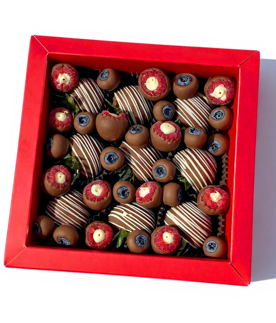 Mira Box – milk chocolate strawberries with white drizzle, paired with raspberries and blueberries, Dubai gift box
