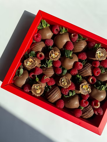 Fatima Box – milk chocolate strawberries topped with raspberries, truffles, and gold accents, bold Dubai gift box
