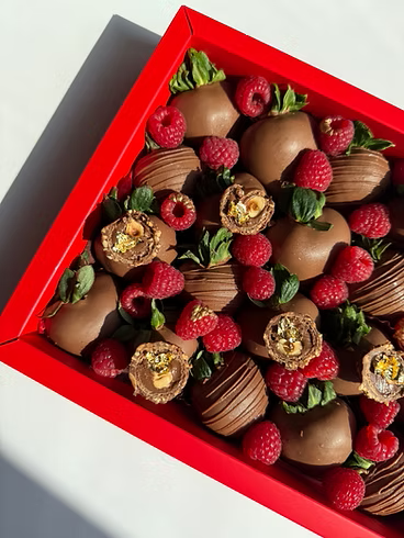 Fatima Box – milk chocolate strawberries topped with raspberries, truffles, and gold accents, bold Dubai gift box