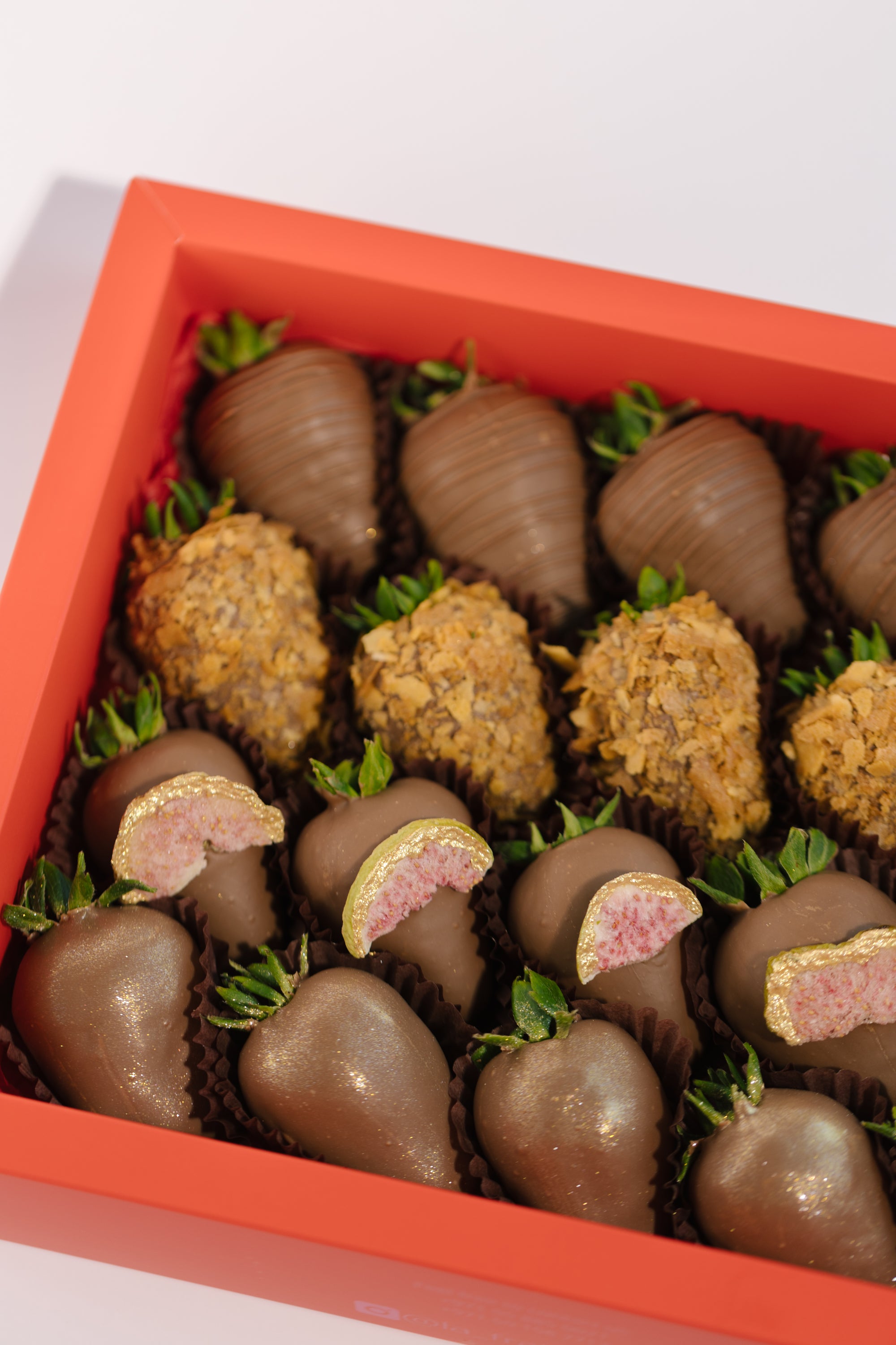 Zaynab Box – milk chocolate strawberries with fig, wafer flakes, stripes, and gold dust, textured Dubai gift box